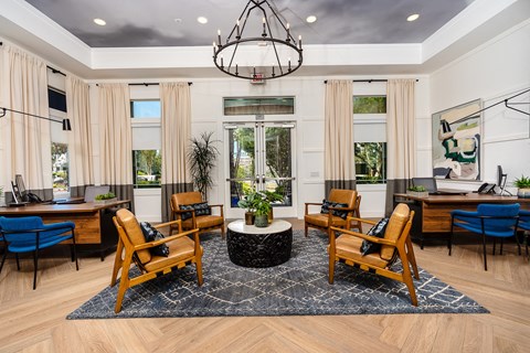 a living room filled with furniture and a large chandelier